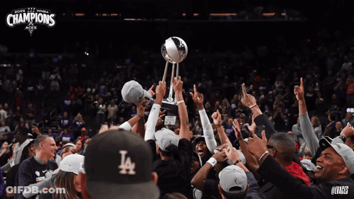A Group Of People Holding Up A Trophy With The Word Champions On It GIF