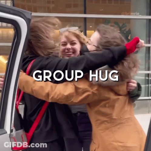 A Group Of People Hugging Each Other With The Words Group Hug Below Them GIF