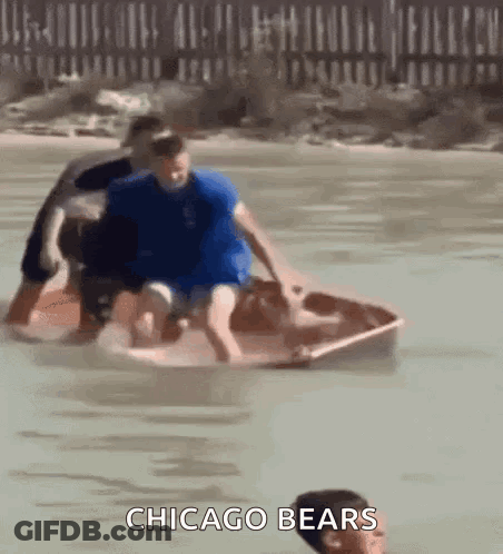 A Group Of People In A Boat In The Water With The Words Chicago Bears On The Bottom . GIF
