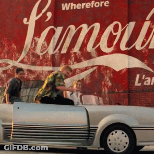 A Group Of People In A Car In Front Of A Sign That Says " Wherefore Famous " GIF