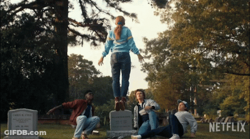 A Group Of People In A Cemetery With Netflix Written On The Bottom GIF
