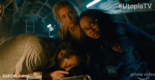A Group Of People In A Dark Room With # Utopiatv On The Bottom Right GIF