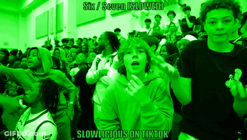 A Group Of People In A Green Room With The Words Six / Seven Slowed GIF