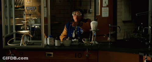 A Group Of People In A Lab With The Words " The Computer " On The Table GIF