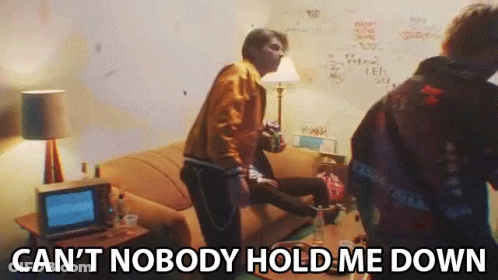 A Group Of People In A Living Room With The Words Can 'T Nobody Hold Me Down Written On The Bottom GIF