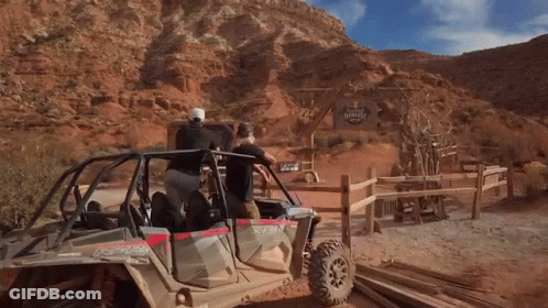 A Group Of People In A Polaris Atv In The Desert GIF