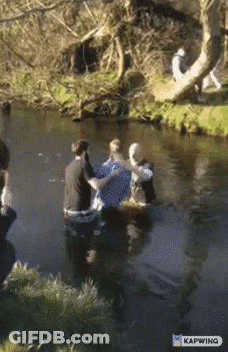 A Group Of People In A River With Kapwing Written On The Bottom Right GIF