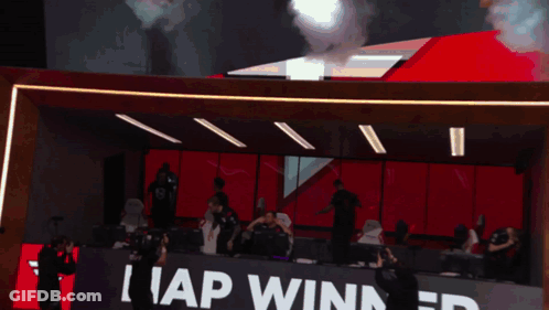 A Group Of People In A Room With A Sign That Says I Ap Winner GIF