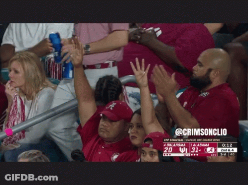 A Group Of People In A Stadium Watching A Football Game Between Oklahoma And Ucla GIF