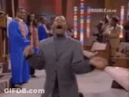 A Group Of People In Blue Robes Are Standing In A Room With A Blurred Background . GIF