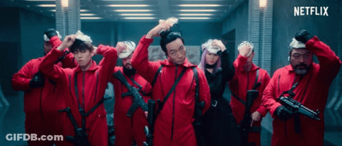 A Group Of People In Red Jumpsuits With Guns And A Netflix Logo In The Corner GIF
