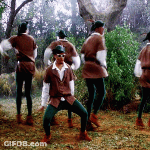 A Group Of People In Robin Hood Costumes Are Dancing GIF