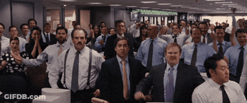 A Group Of People In Suits And Ties Are Dancing In A Room With A Sign That Says ' Equity ' On It GIF
