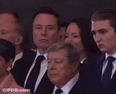 A Group Of People In Suits And Ties Are Sitting Together GIF