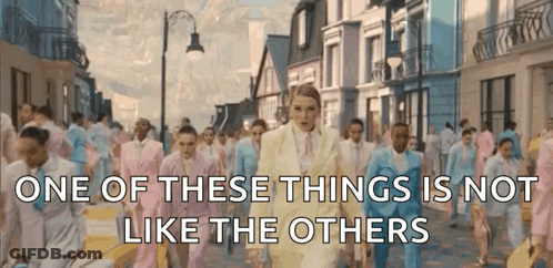 A Group Of People In Suits Are Walking Down A Street With The Words One Of These Things Is Not Like The Others GIF