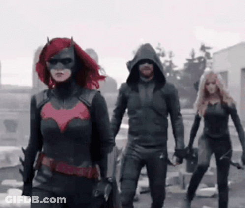 A Group Of People In Superhero Costumes Are Walking In A Line GIF