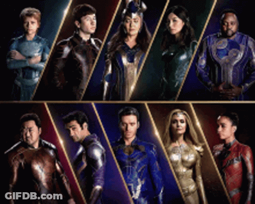 A Group Of People In Superhero Costumes Standing Next To Each Other . GIF