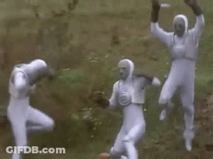 A Group Of People In White Suits Are Fighting Each Other . GIF
