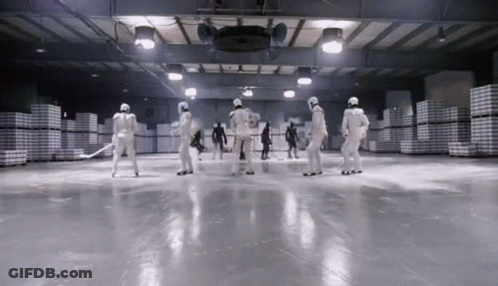 A Group Of People In White Uniforms Are Standing On A Ice Rink GIF