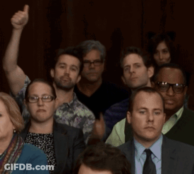 A Group Of People Including A Man In A Suit And Tie Giving A Thumbs Up GIF