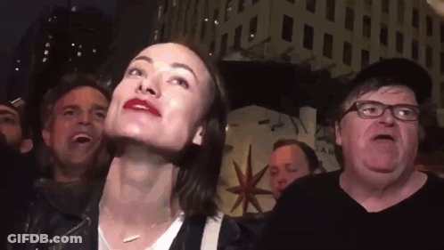 A Group Of People Including A Man With Glasses And A Woman With Red Lips GIF