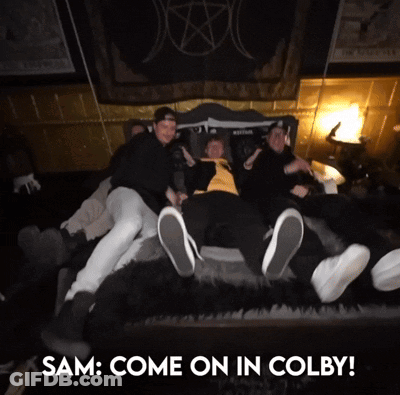 A Group Of People Laying On A Bed With The Words " Sam Come On In Colby " Above Them GIF