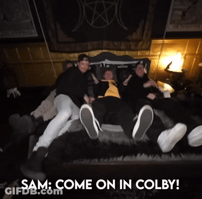 A Group Of People Laying On A Bed With The Words " Sam Come On In Colby " GIF