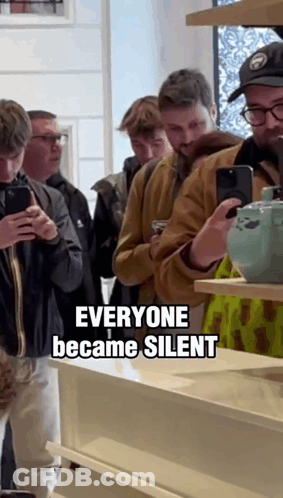 A Group Of People Looking At Their Phones With The Words Everyone Became Silent Above Them GIF