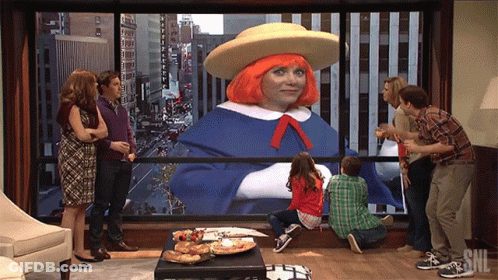 A Group Of People Looking Out A Window With Snl Written On It GIF