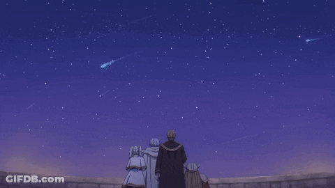 A Group Of People Looking Up At A Night Sky With Shooting Stars GIF