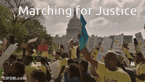 A Group Of People Marching For Justice With A Capitol Building In The Background GIF