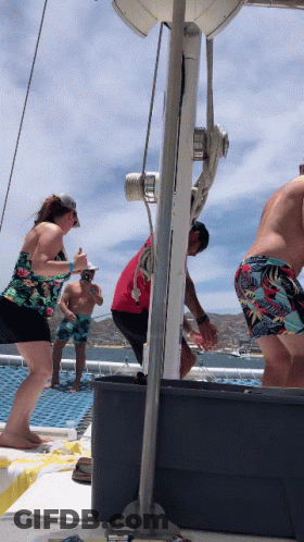 A Group Of People On A Boat Including A Man In A Red Shirt And A Woman In A Floral Top GIF
