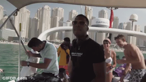 A Group Of People On A Boat With A Garmin On The Top GIF