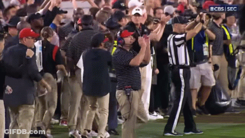 A Group Of People On A Field With A Cbs Sec Logo In The Corner GIF