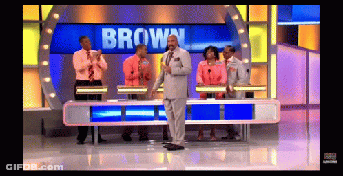 A Group Of People On A Game Show With The Name Brown On The Screen GIF