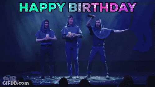 A Group Of People On A Stage With The Words Happy Birthday Written Above Them GIF