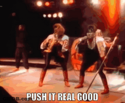 A Group Of People On A Stage With The Words Push It Real Good On The Bottom GIF