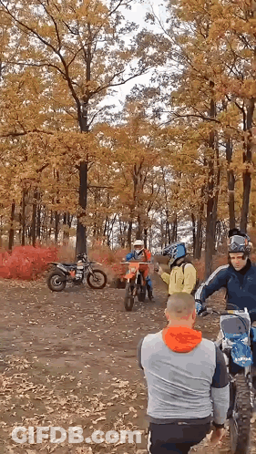 A Group Of People On Dirt Bikes In The Woods GIF