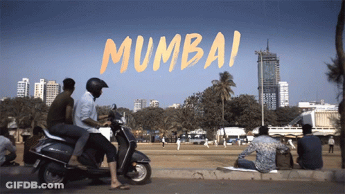 A Group Of People On Scooters In Front Of A Sign That Says ' Mumbai ' On It GIF