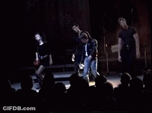 A Group Of People On Stage With The Words You 'Re Playin ' With Fire GIF