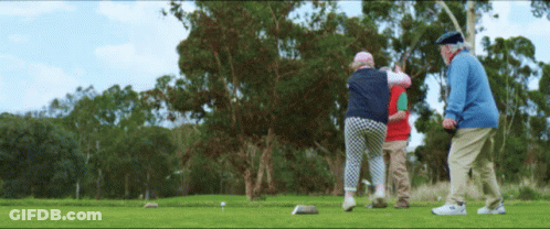 A Group Of People Playing Golf On A Green GIF