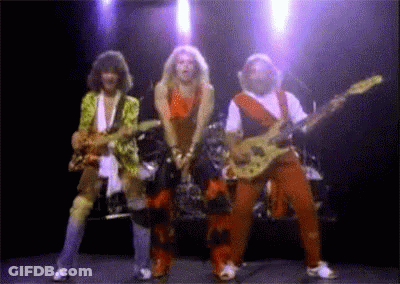 A Group Of People Playing Guitars On Stage GIF