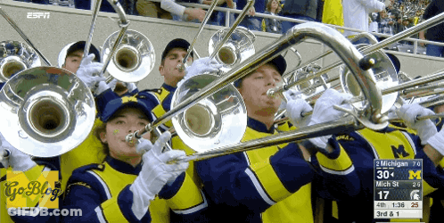 A Group Of People Playing Trombones With The Espn Logo On The Bottom Right GIF