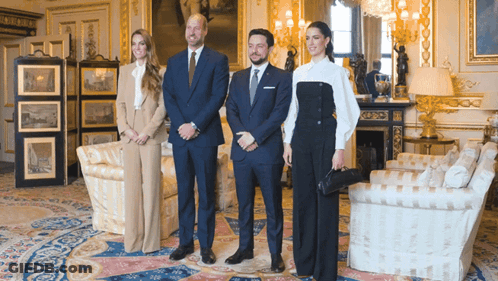 A Group Of People Posing For A Photo In A Room GIF