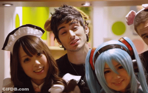A Group Of People Posing For A Picture Including One Wearing A Maid Outfit GIF