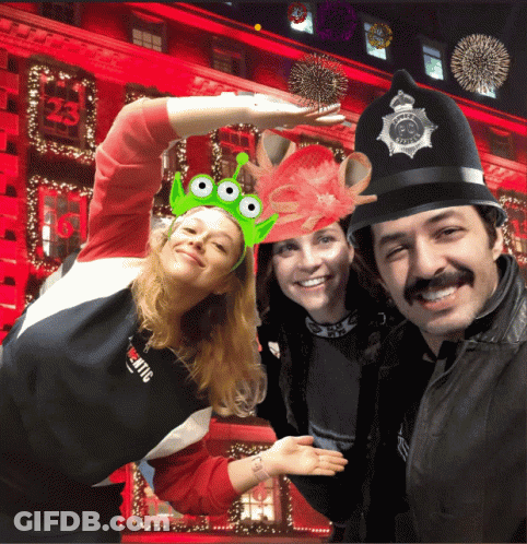 A Group Of People Posing For A Picture With One Wearing A Hat With The Number 23 On It GIF