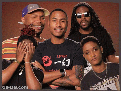 A Group Of People Posing For A Picture With One Wearing A Shirt That Says Bisoba On It GIF