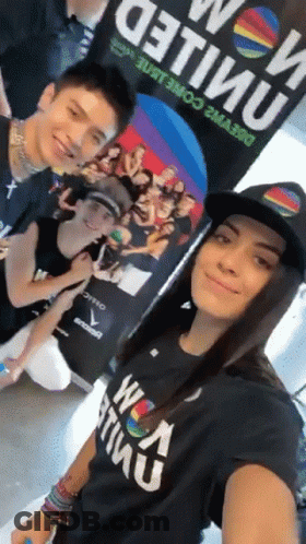 A Group Of People Posing For A Picture With One Wearing A Shirt That Says ' United ' On It GIF
