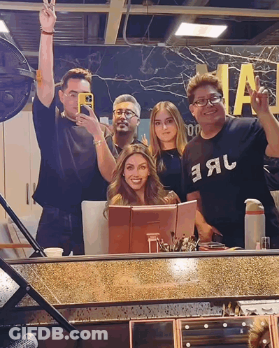 A Group Of People Posing In Front Of A Mirror With One Wearing A Shirt That Says Earl GIF
