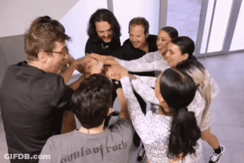 A Group Of People Putting Their Hands Together And One Of Them Has A Shirt That Says Souls Of Rock On It GIF